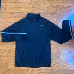 Nike mens small mens black zipper jacket with gray stripe and front pockets.
